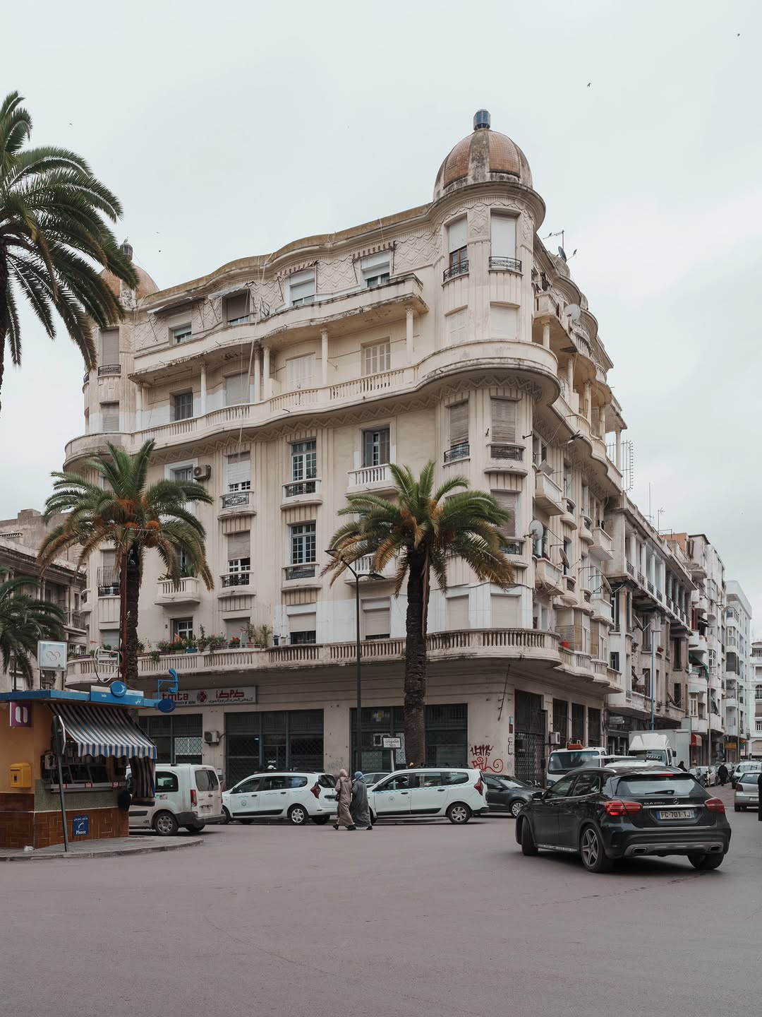 Mauresque Corner Building 1930s Mauresque Art Deco corner building with carved friezes and palms in Casablanca