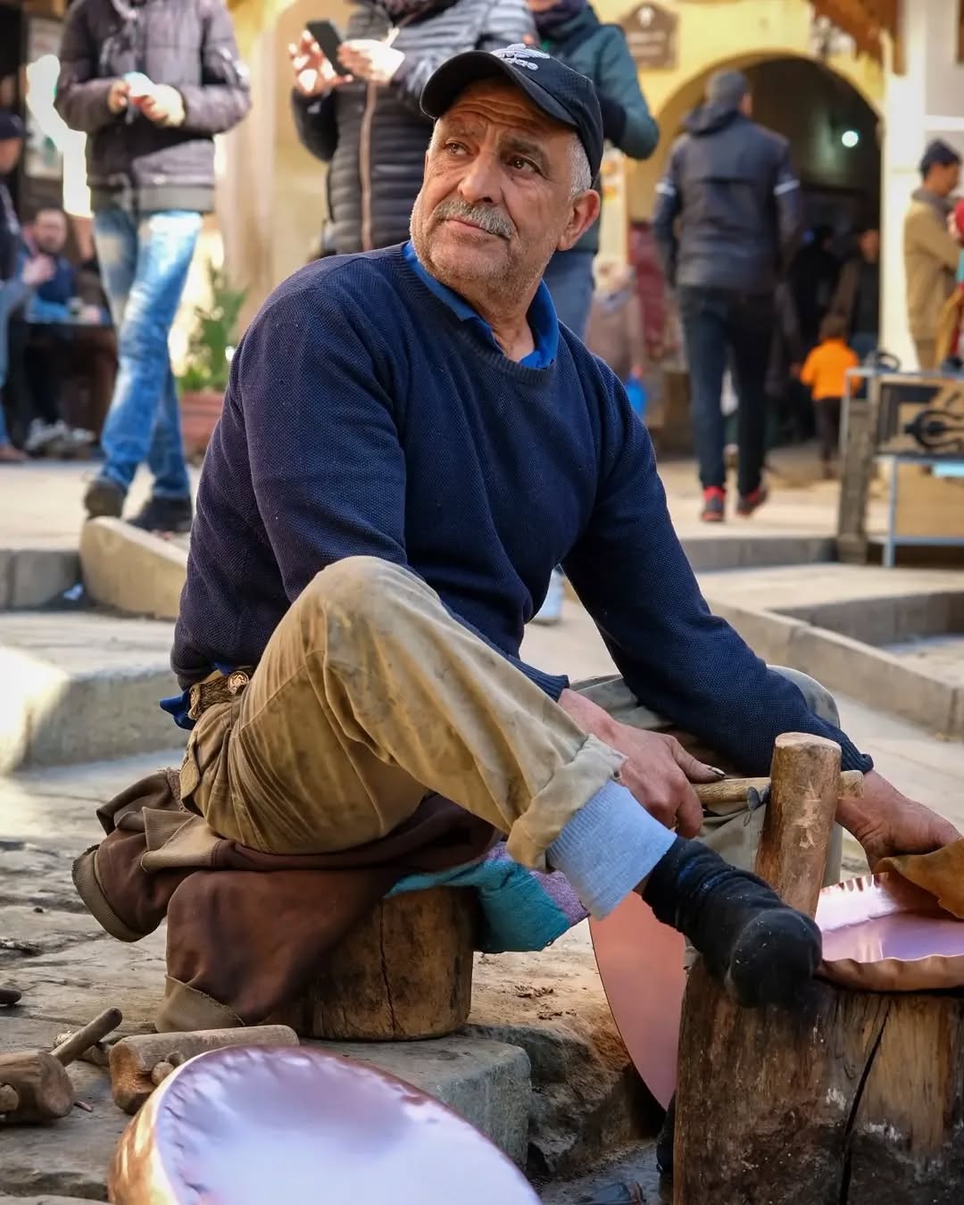 Seffarine Square Seated Fes coppersmith resting in Seffarine Square between pieces
