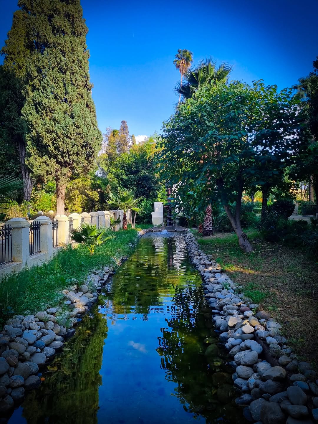 Jnan Sbil Stream Stone-lined reflective stream in Jnan Sbil garden, Fes
