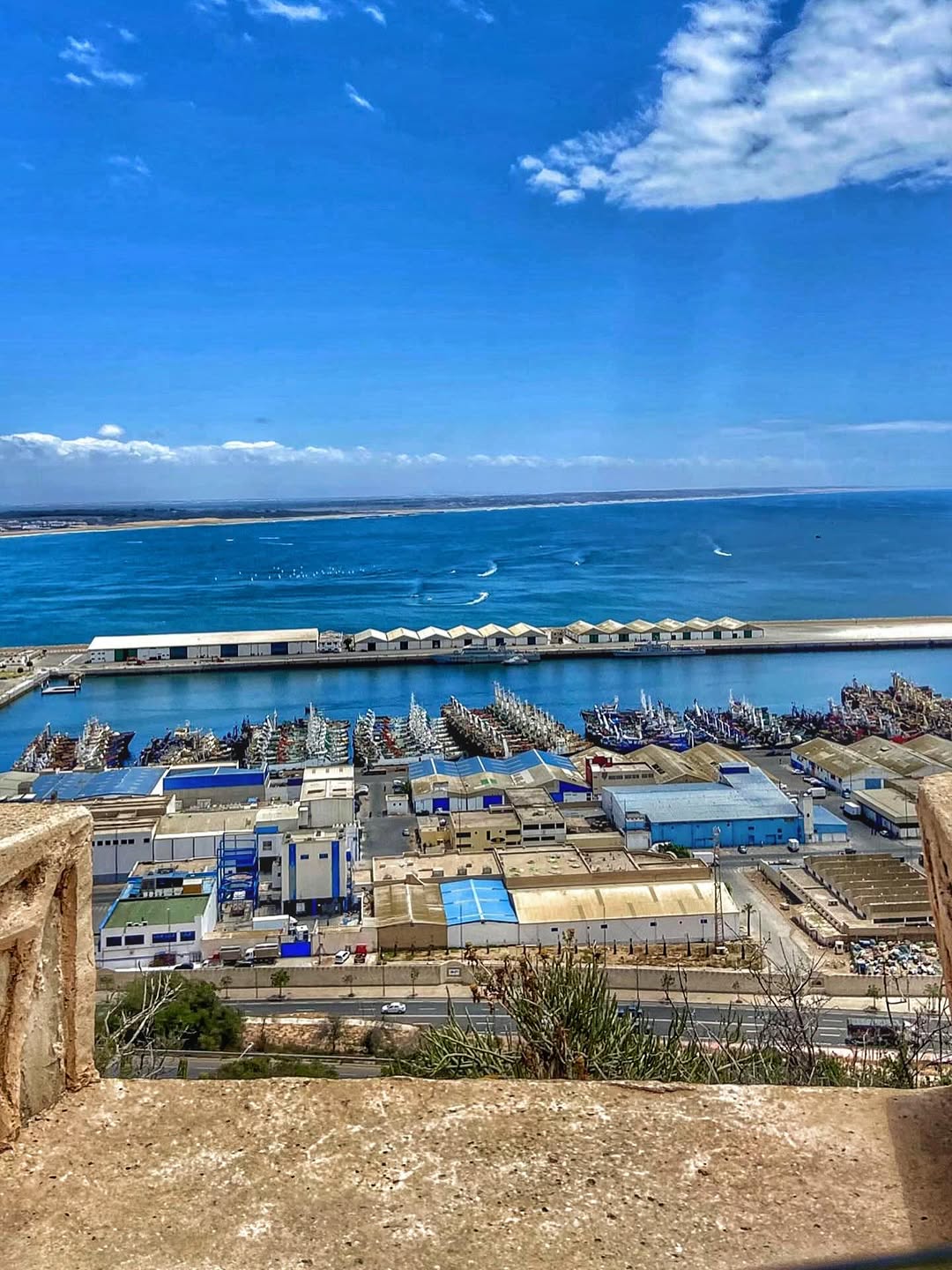 Working Fishing Port Agadir fishing port with blue trawlers and Atlantic horizon from the kasbah viewpoint