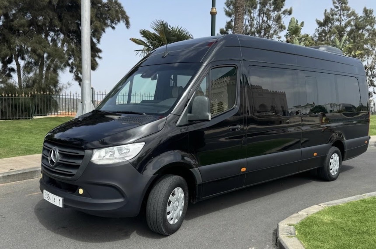 Black Mercedes-Benz Sprinter luxury minibus parked in front of the Royal Palace for group transportation in Morocco