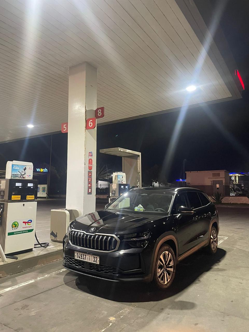 Black Škoda Kodiaq refuelling at a Total service station at night in Morocco