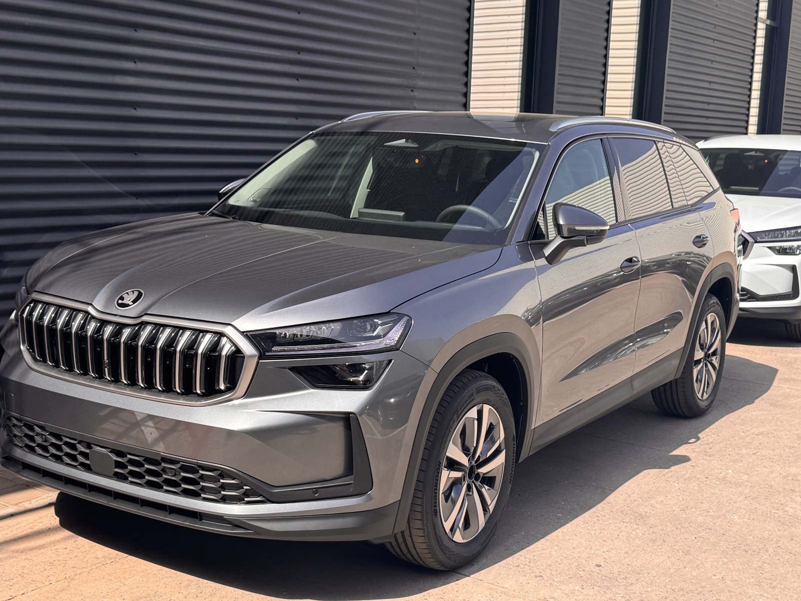New grey Škoda Kodiaq SUV with chrome grille at the showroom
