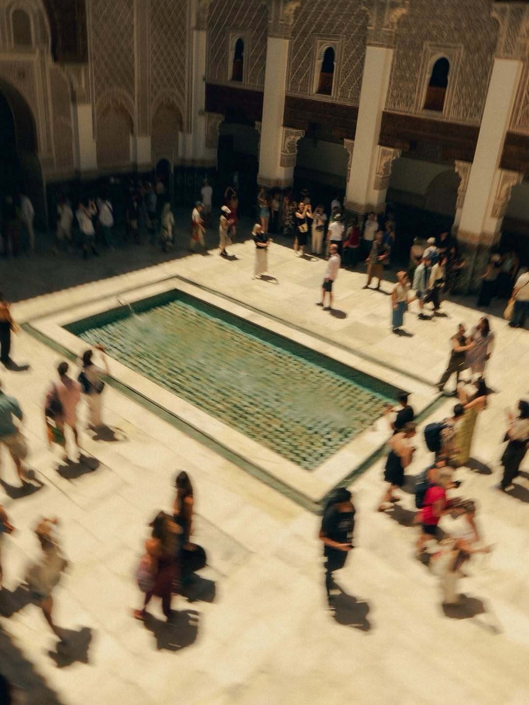 Madrasa Courtyard Crowd of visitors around the reflecting pool at Ben Youssef Madrasa, Marrakech