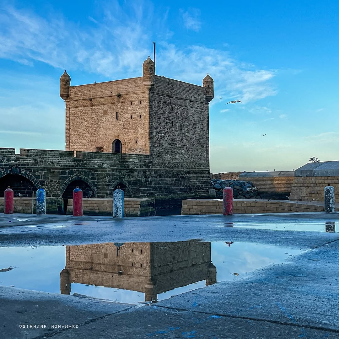 Historic Skala fortress and Portuguese ramparts reflected in tidal pools at Essaouira port, Morocco — UNESCO World Heritage coastal city