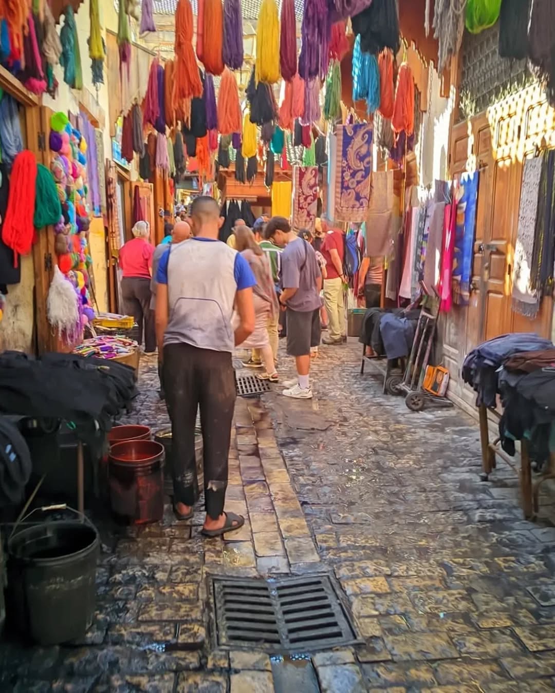 Dyers' Souk Hanging colorful wool skeins above a busy Fes dyers' souk